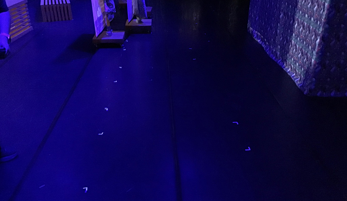 Fluorescent positioning marks placed on the floor